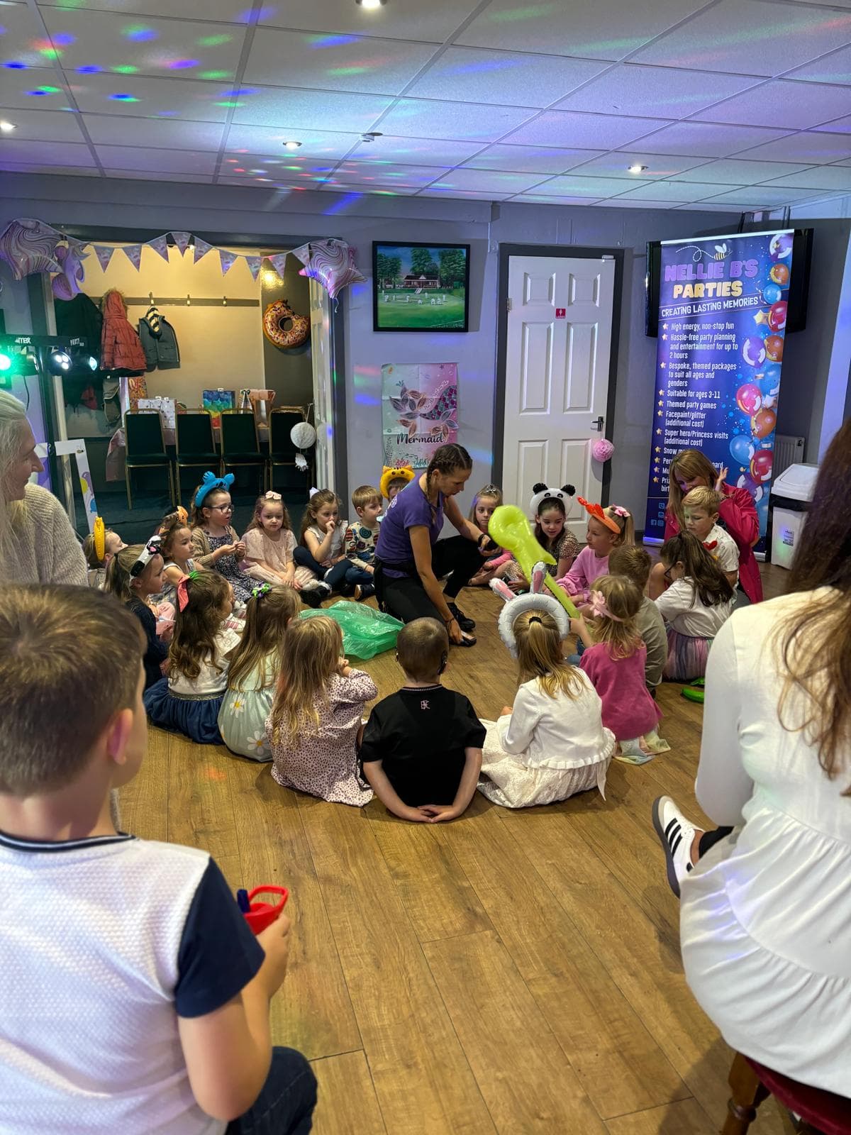 Children sitting in a circle ready for party games