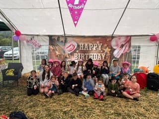 Colourful outdoor birthday sign welcoming guests to a Nellie B's celebration