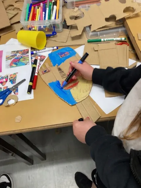 Creating crafts at a table covered in art supplies
