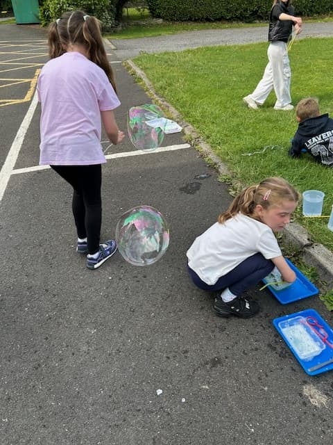 Child chasing bubbles during outdoor play